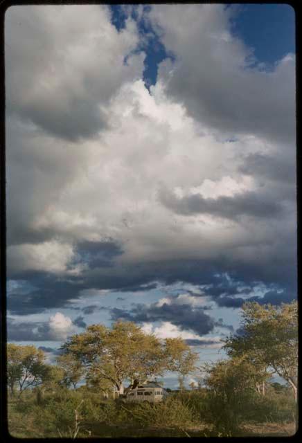 Distant view of Jeep, with cloudy blue sky in the background