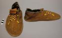 Pair of moccasins, possibly Sioux. Hard soles w/ leather uppers. Seam up heel.