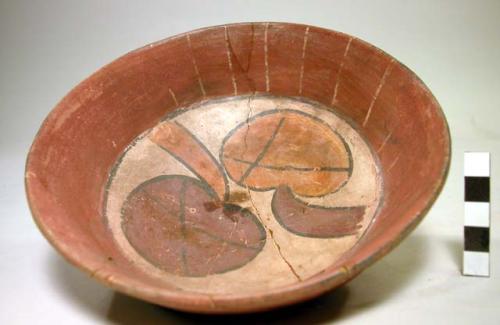 Polychrome pottery bowl with fruit design in center