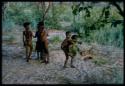 Five children at play, including one boy carrying another on his back