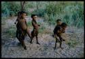 Five children at play, including one boy carrying another on his back