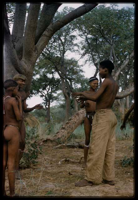 Group of older boys gathered at !’hu kuitzi (veldkos game)