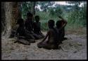 Group of children sitting in facing rows, probably playing a game