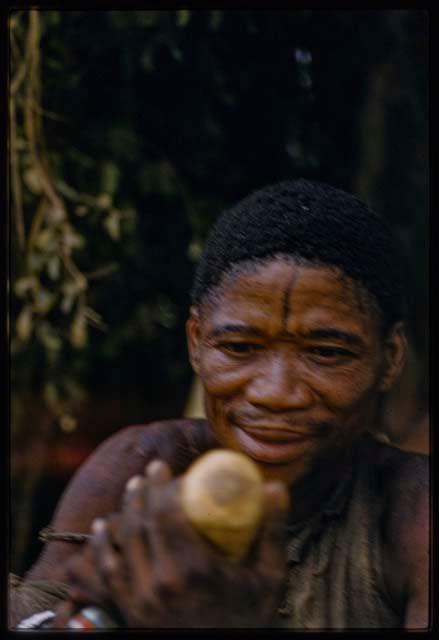 Gumtsa of Samangaigai group looking at something held in his hands