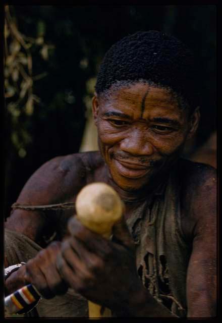 Gumtsa of Samangaigai group looking at something held in his hands