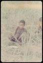 Two boys sitting in the grass