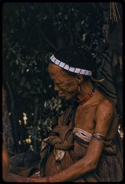 Di!ai in profile, wearing a beaded band on her head