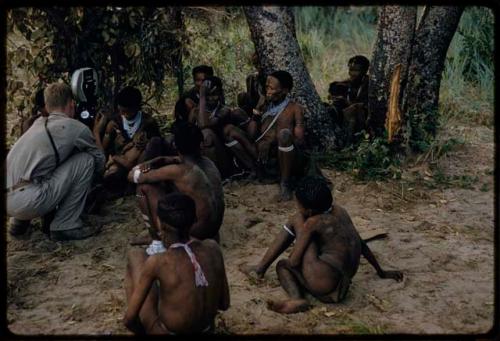 John Marshall filming a group of people in rainy season