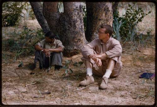 Nicholas England and a man sitting near trees