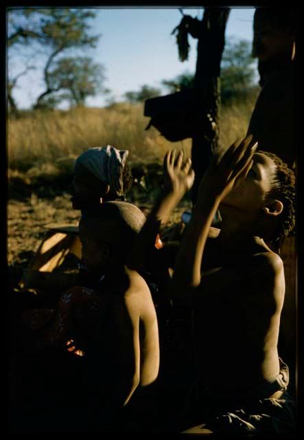 Child sitting and tossing something in the air