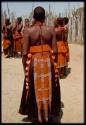 One of the wives of Chief Nehemiah, wearing a decorated skirt and shells, view from behind