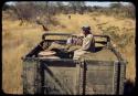 Laurence Marshall sitting on top of the expedition Dodge truck, referred to as "Hardship No. 57"