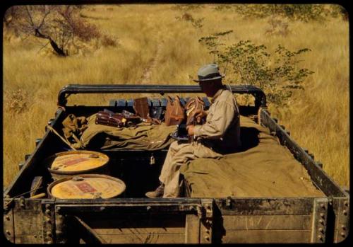 Laurence Marshall sitting on top of the expedition Dodge truck, referred to as "Hardship No. 57"