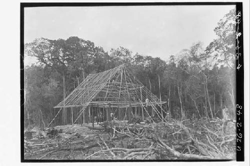 Men working on house construction frame