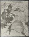 Boy looking at a petroglyph of two rhinos