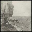 Men sitting in front of an entrance to a cave at Poggenpool Farm