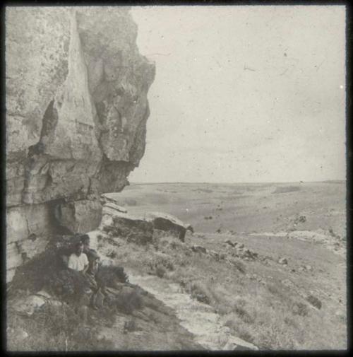 Men sitting in front of an entrance to a cave at Poggenpool Farm