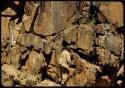 Merl La Voy next to a petroglyph at Scho-Scho, of a giraffe and a small animal with large paws