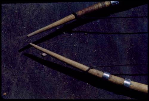 Bow: Loop ends of two bows, one shows two metal bands, one shows wide sinew wrapping