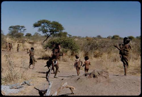 Children, Groups, play: Group of girls playing Tamah n!o’an (ball game); the girl running up the hill has just thrown the ball to the girl at the right who is catching it