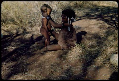 Children, Groups, play: N!ai sitting with Sa≠gai standing in front of her