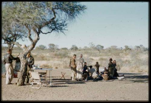 People sitting and standing in the expedition camp