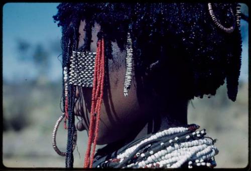 Ornament: ≠Gisa (daughter of ≠Gao and Khwo//o-/gasa), close-up showing decoration of black fat and charcoal on her temple and in her hair