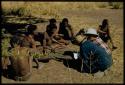 Expedition, Ethnographic work: Group of people throwing oracle disks, with Laurence Marshall and Kernel Ledimo taking notes