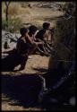 Music: Three people sitting and singing next to "/Gao Music" playing a //guashi for a sound recording