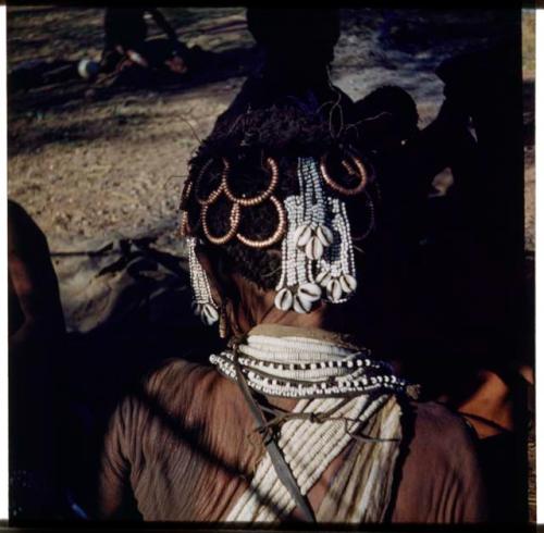 Ornament: Woman wearing cowrie shells in her hair, possibly "Old /Gam," view from behind (half of stereo 2001.29.5953)