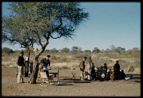 Expedition, Camp: Group of people sitting and standing with Heiner Kretzschmar, Laurence Marshall and other expedition staff members in the expedition camp