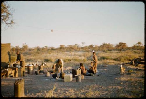 Expedition, Cooking: Boys watching Philip Hameva cooking, with Franz Rudolph washing dishes near them