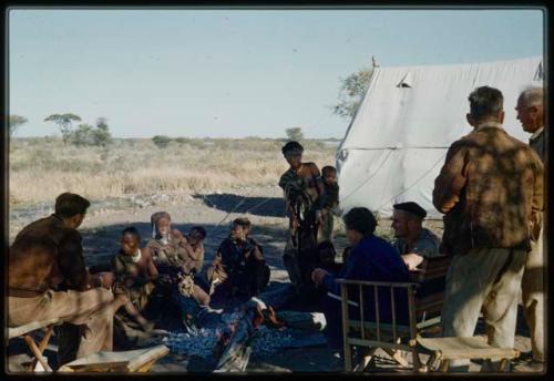 Expedition, Groups: !Ungka, /Gasa (/Qui's wife), "Old /Gam," and //Kushay sitting in the expedition camp with Hans Ernst, two visiting prospectors from Johannesburg, and Lorna Marshall