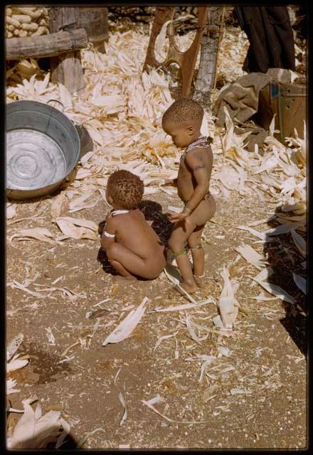 Expedition, Metzger: Two children playing near a pile of corn husks