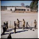 Otjinene: Men standing next to a fence, view from an expedition truck (half of stereo 2001.29.5590)