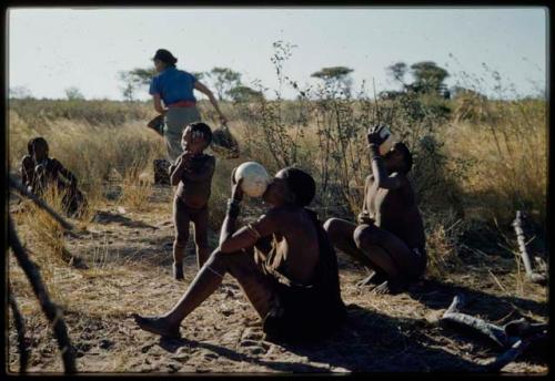 Expedition, Personnel: People sitting and drinking from ostrich egg shells, with Anneliese Scherz walking in the background