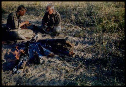 Expedition, Personnel: John Marshall and Laurence Marshall sitting on the ground next to a fire