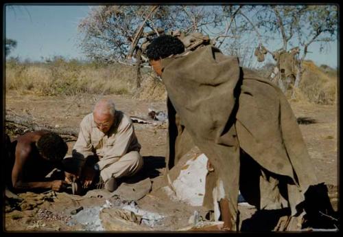 Expedition, Personnel: "Old Gau" fixing Laurence Marshall's shoe, with another person standing next to them