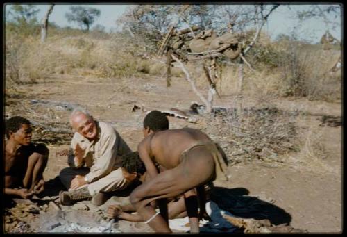 Expedition, Personnel: "Old Gau" fixing Laurence Marshall's shoe, with two other people watching