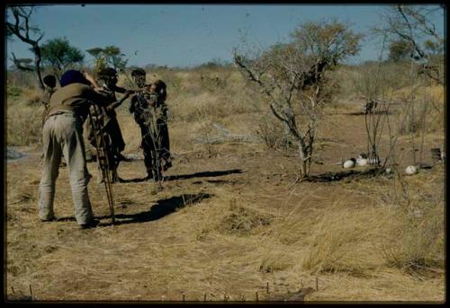 Expedition, Photography: People participating in a burning arch ceremony, with John Marshall filming them