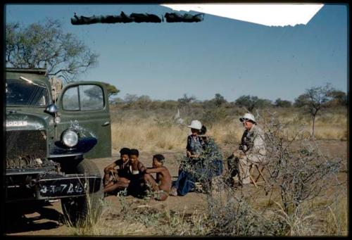 Expedition, Sound Recording: "/Gao Music" singing, sitting with a group of people, being recorded with a microphone in an expedition truck, with Lorna Marshall and Laurence Marshall sitting next to them