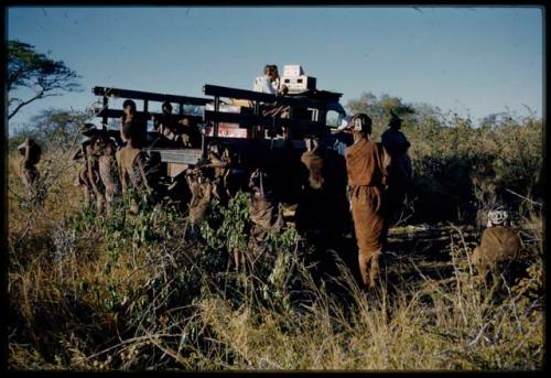 Expedition, Sound Recording: People standing next to an expedition truck, with Hans Ernst sitting with sound recording equipment in the truck