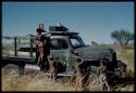 Expedition, Sound Recording: Boys standing on and next to an expedition truck, with Hans Ernst sitting with sound recording equipment in the truck