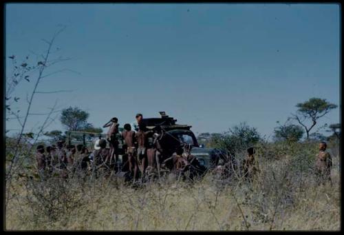 Expedition, Trucks: Group of boys standing next to an expedition truck, with Hans Ernst sitting with sound recording equipment in the truck