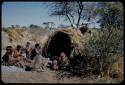 "/Qui Hunter" sitting with family and visitors in front of his skerm