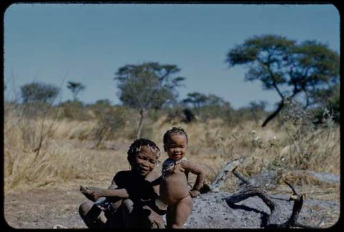 !Ungka (≠Toma's sister) sitting, with a child standing next to her