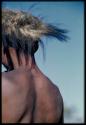 !Naishi wearing a fur headdress, close-up, view from behind