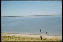 Scenery, Pan: Two people walking in the water of the pan at Thinthuma, with another person walking toward the water