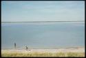 Scenery, Pan: Two people standing at the edge of the pan at Thinthuma, one in the water and one on dry ground