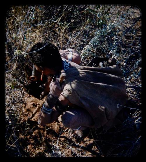 Food Gathering, Children: Woman digging, with her child reaching into the hole